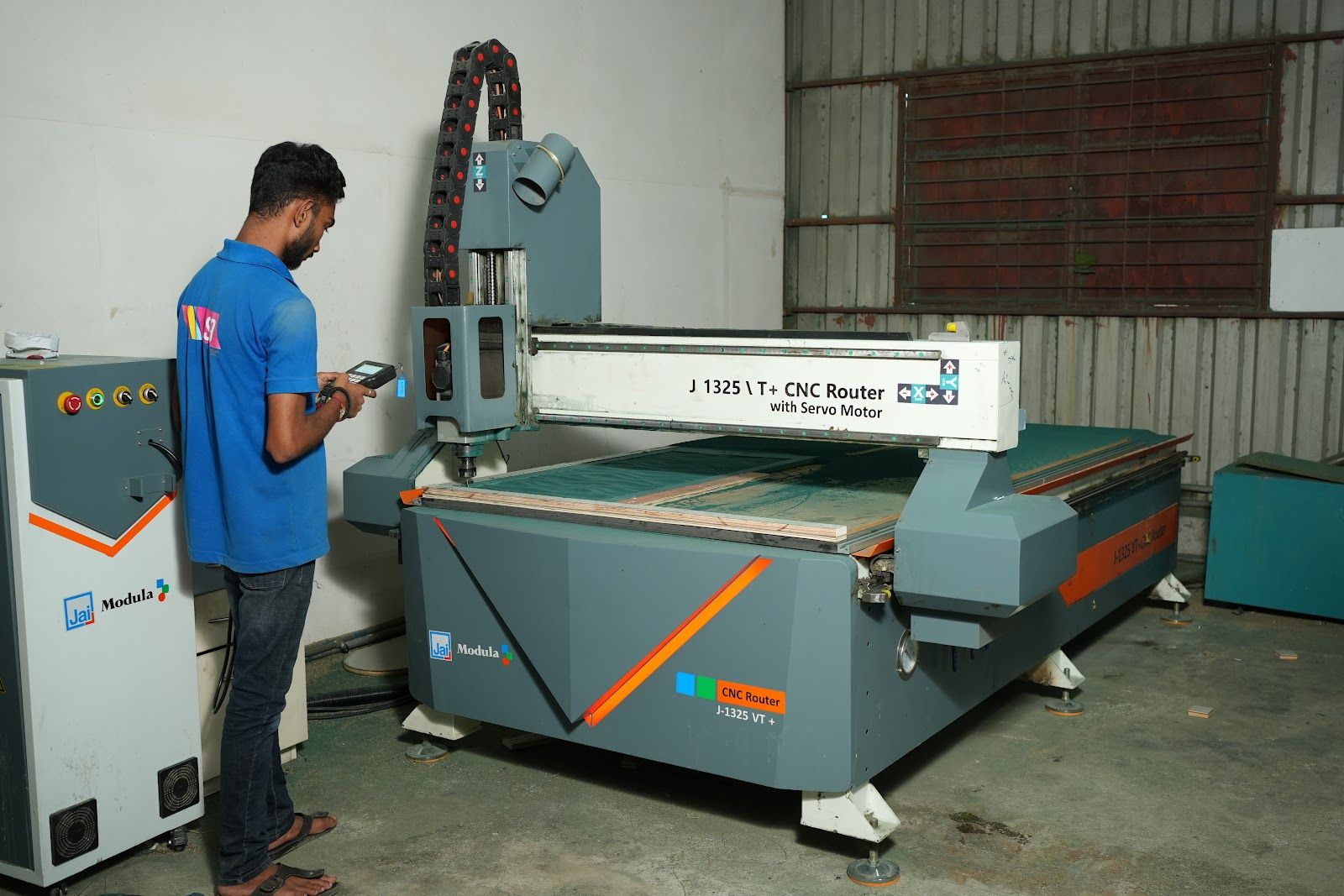 Operator at the CNC router in the AS9 factory