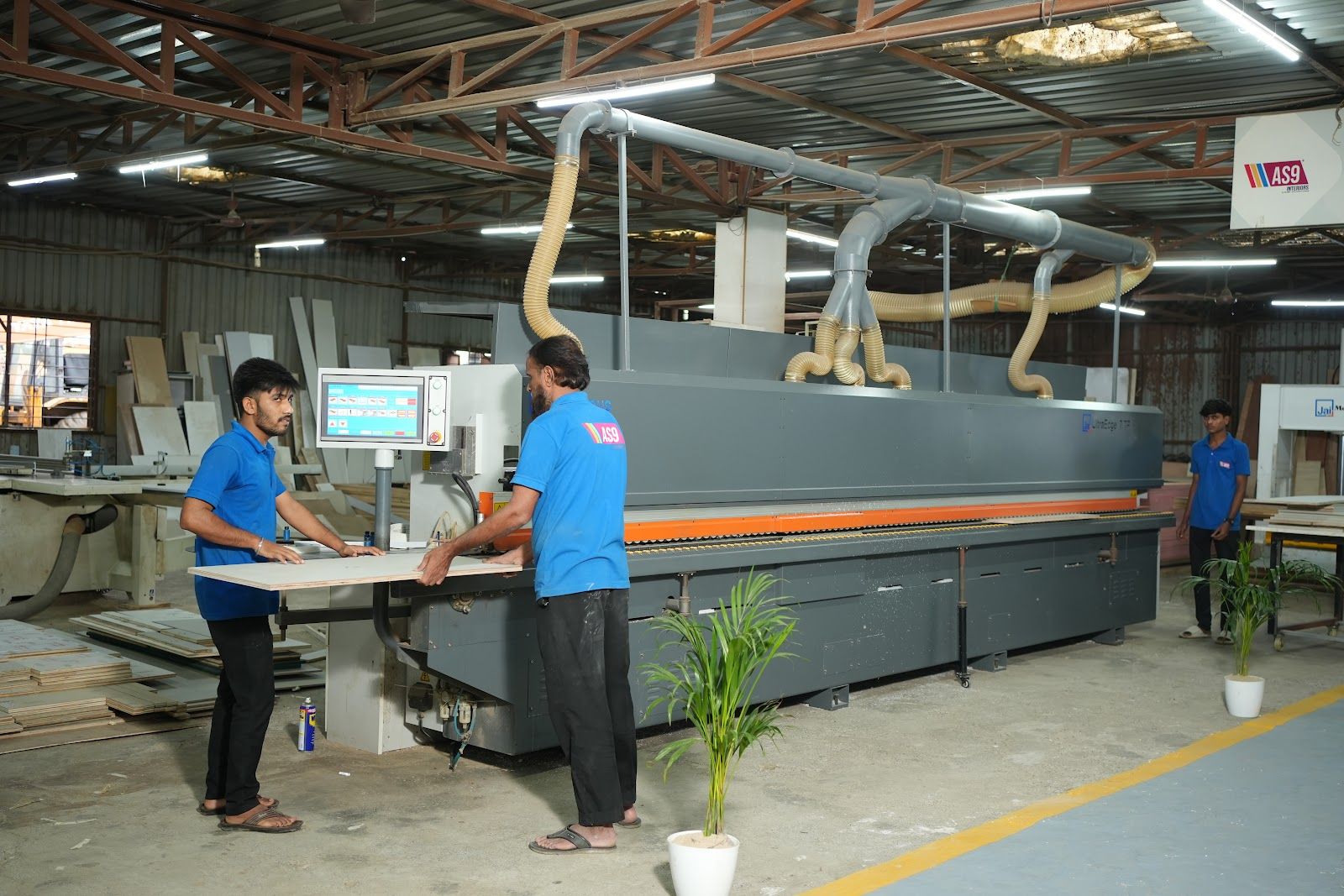 Edge banding machine at the AS9 factory