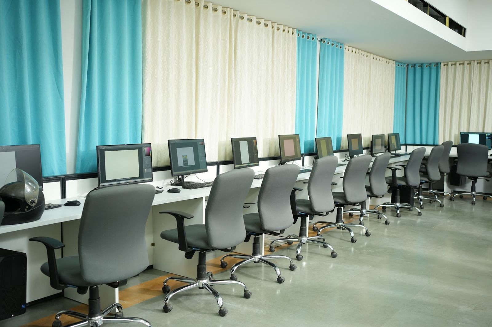 Long rows of computer workstations in an institute lab