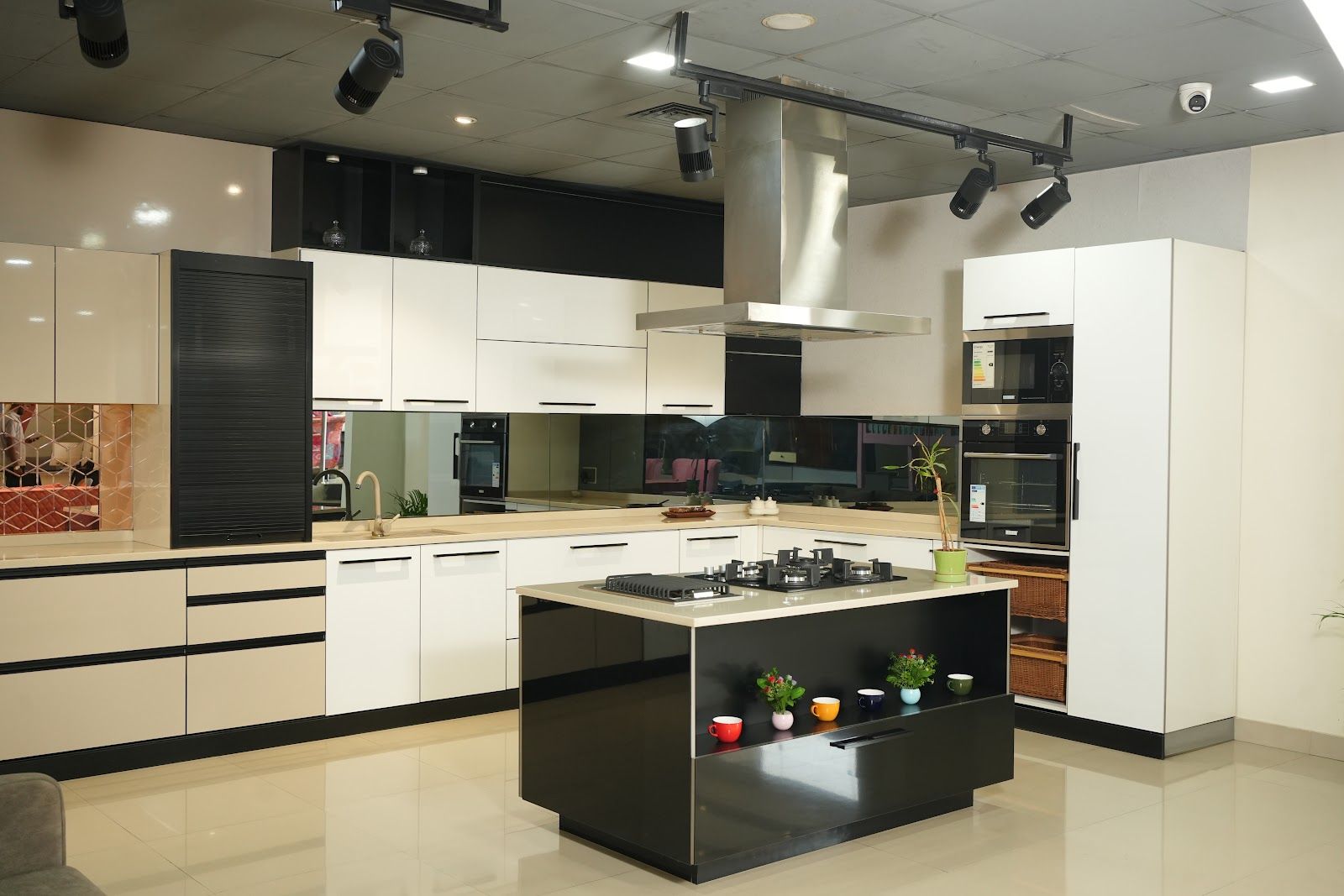 Island kitchen with white and black cabinets on display in the AS9 showroom