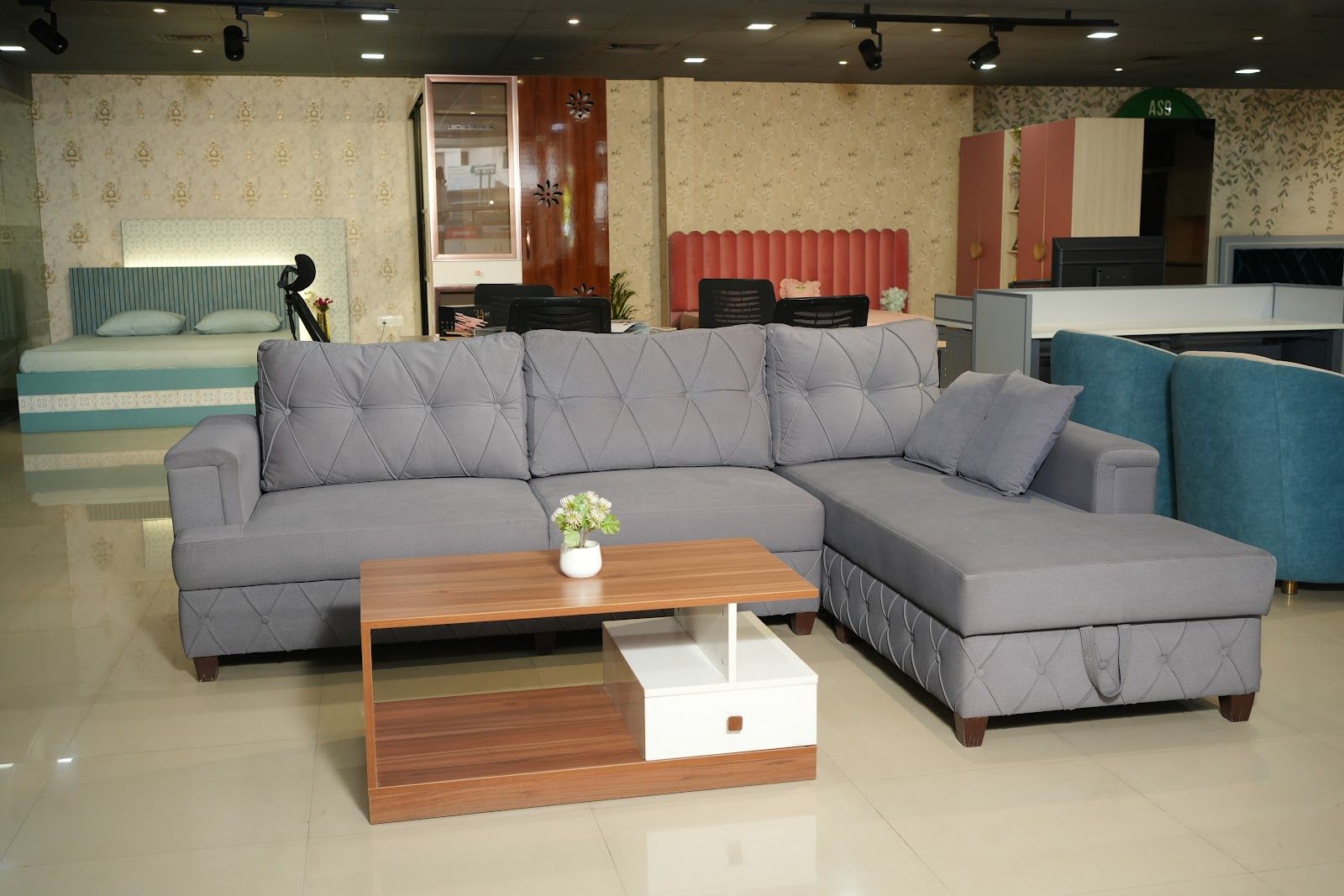 Grey L-shaped sectional sofa with a centre table in the AS9 showroom