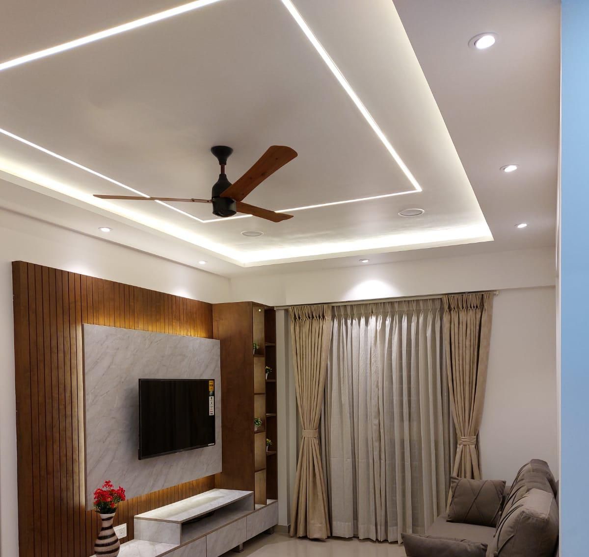 Bedroom TV wall with wooden slats and a false ceiling with cove lighting
