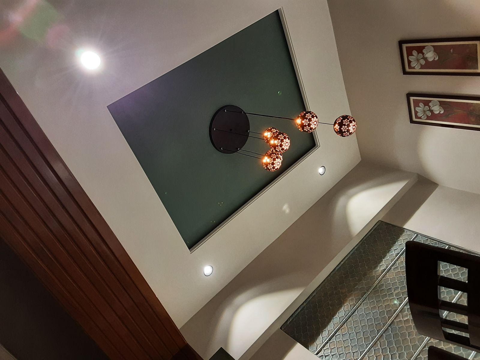 False ceiling with a wooden panel and pendant lights