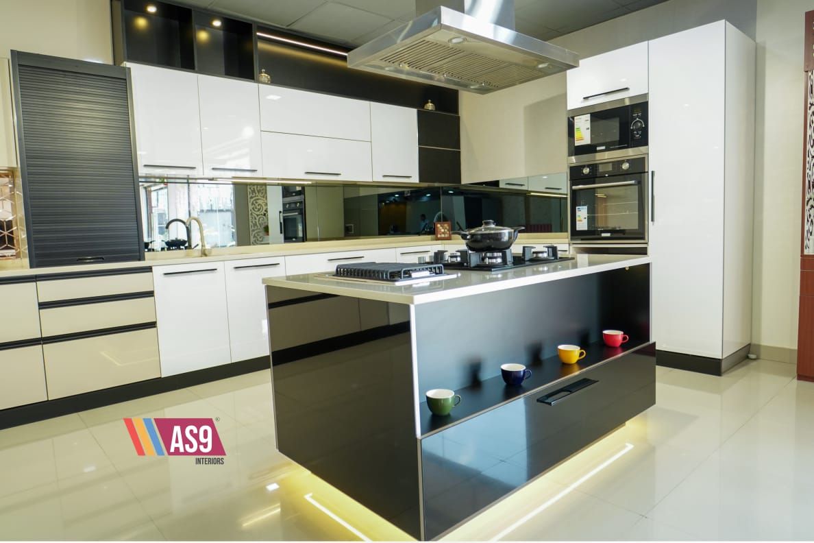 Island kitchen in black and white with tall appliance units, designed and made by AS9 Interiors