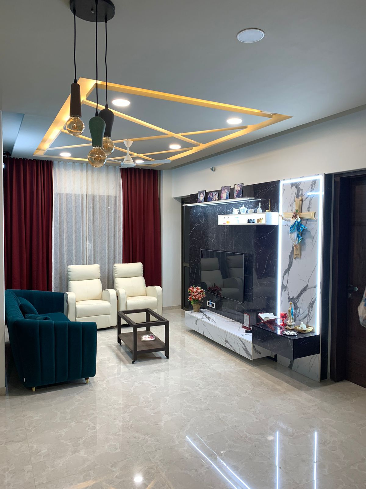 Living room with a TV unit, pendant-lit false ceiling and lounge seating