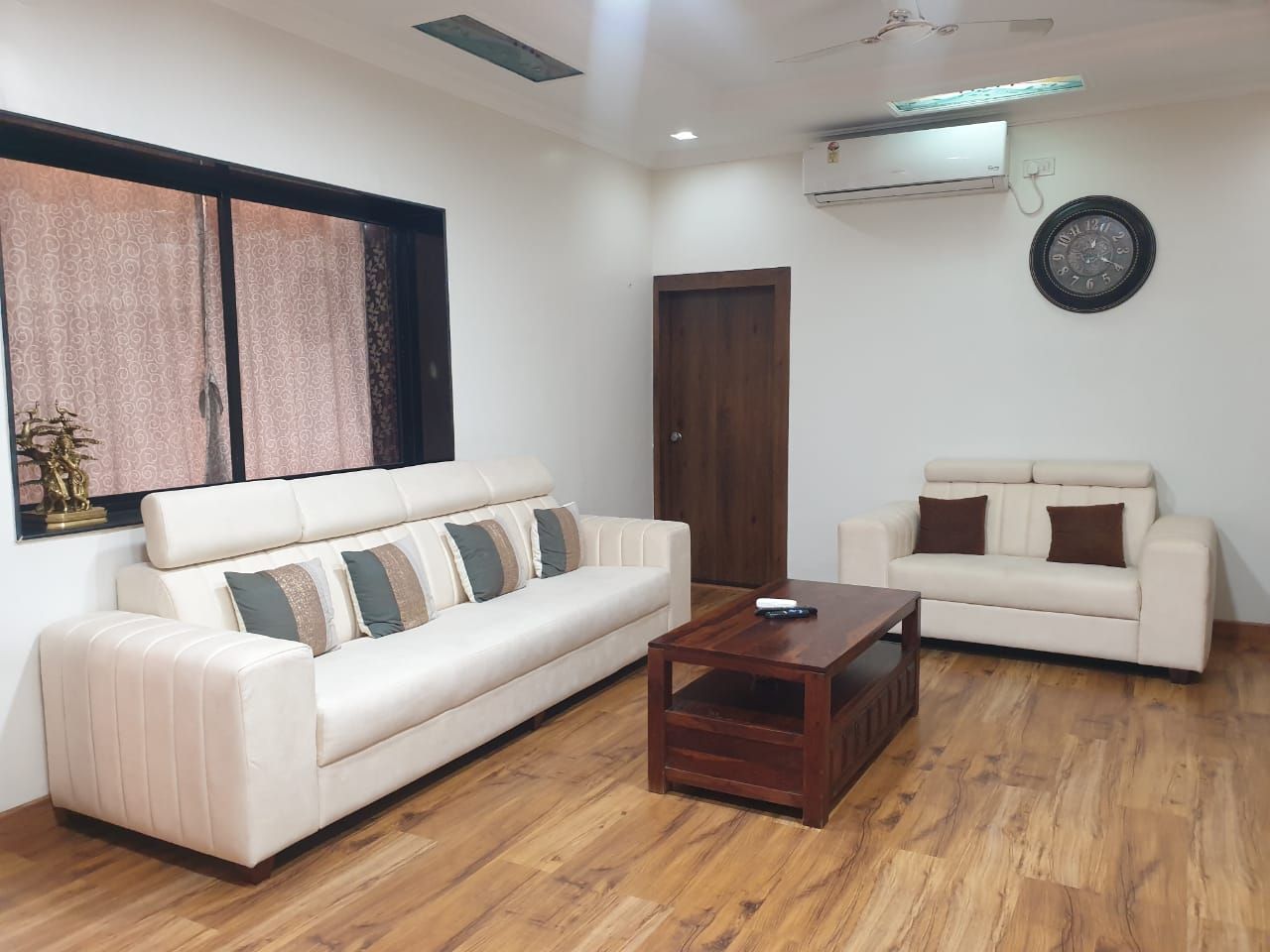 Living room with white sofas and a wooden centre table