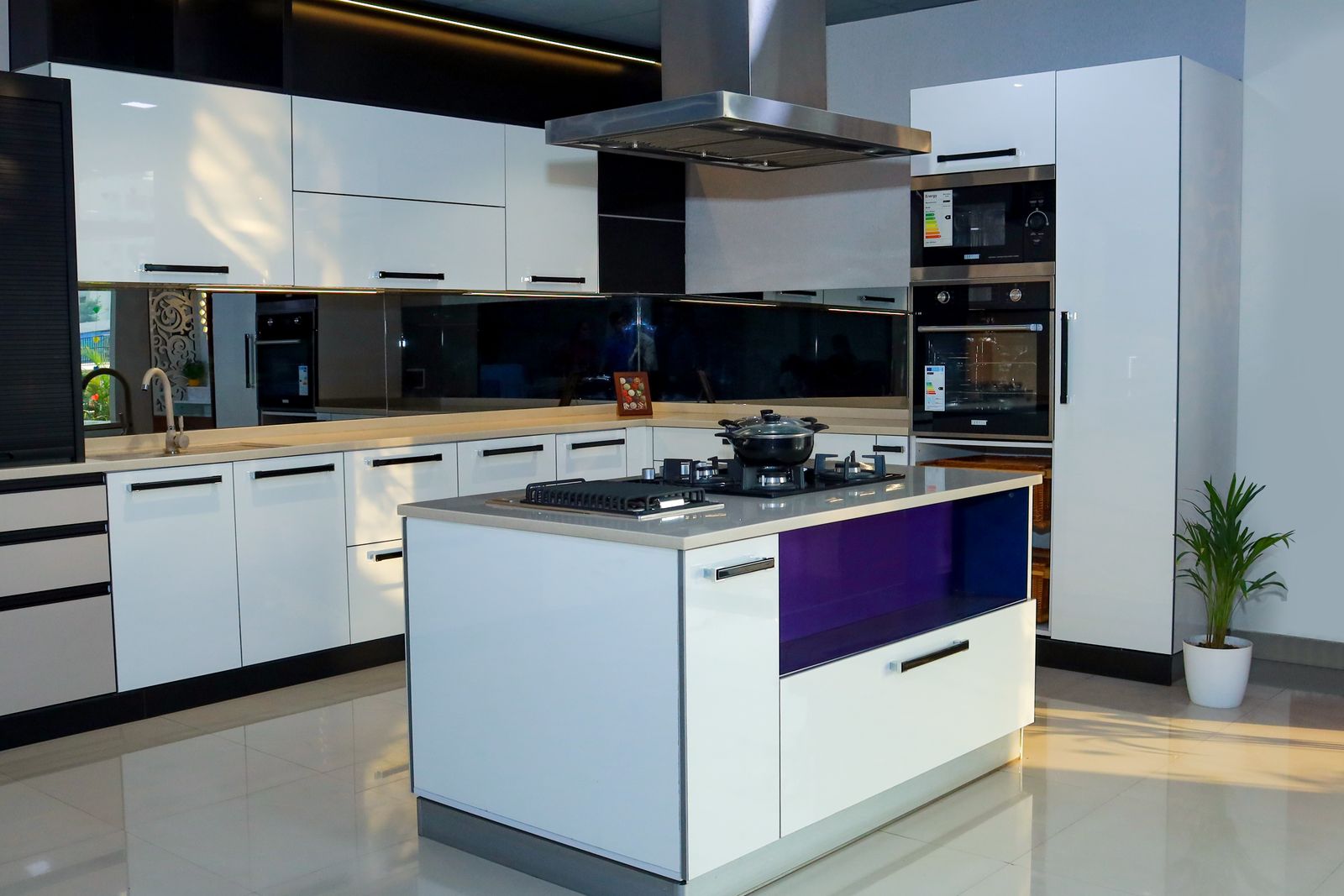 White gloss modular island kitchen with black accents and built-in appliances