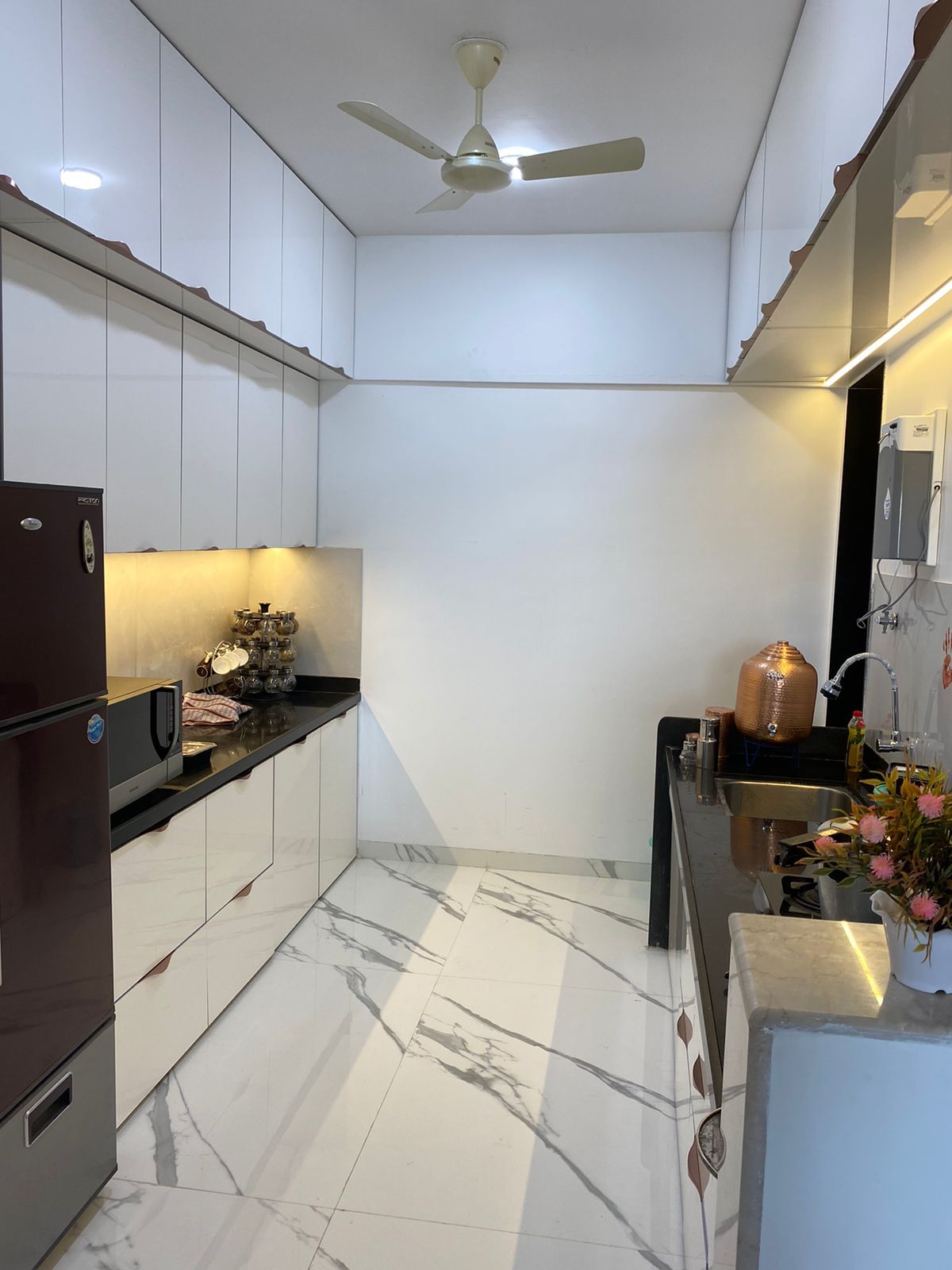 Parallel modular kitchen in white gloss with tall storage units