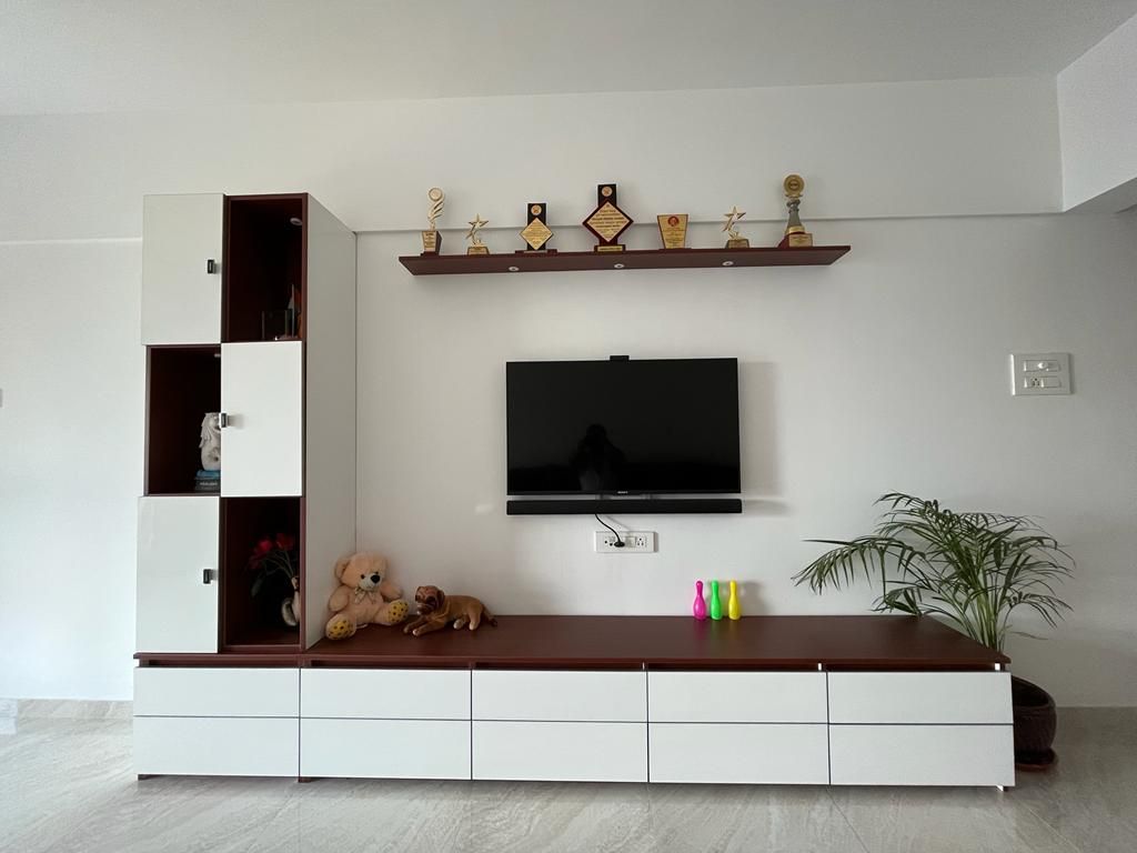 White TV unit with drawers, a floating shelf and display storage